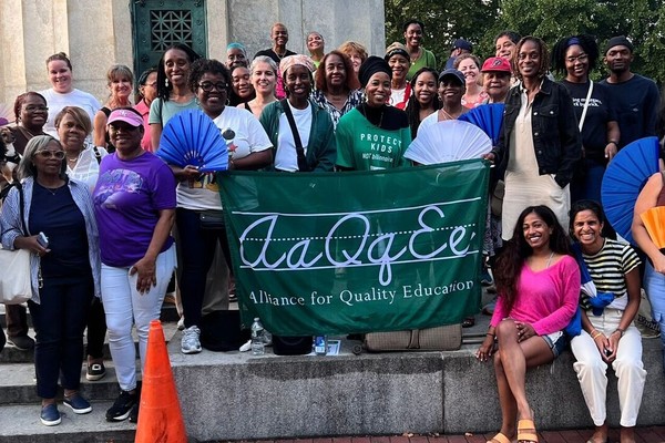 Alliance for Quality Education members and supporters holding an AQE banner.