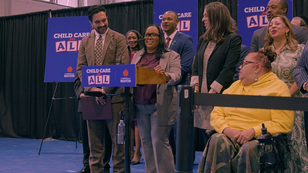 POP provider Ayan Wilson speaks alongside the Mayor and child care advocates.
