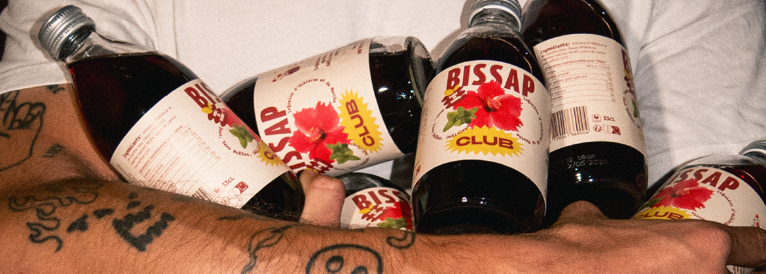 Plusieurs bouteilles dans les bras d'un homme de Bissap Club
