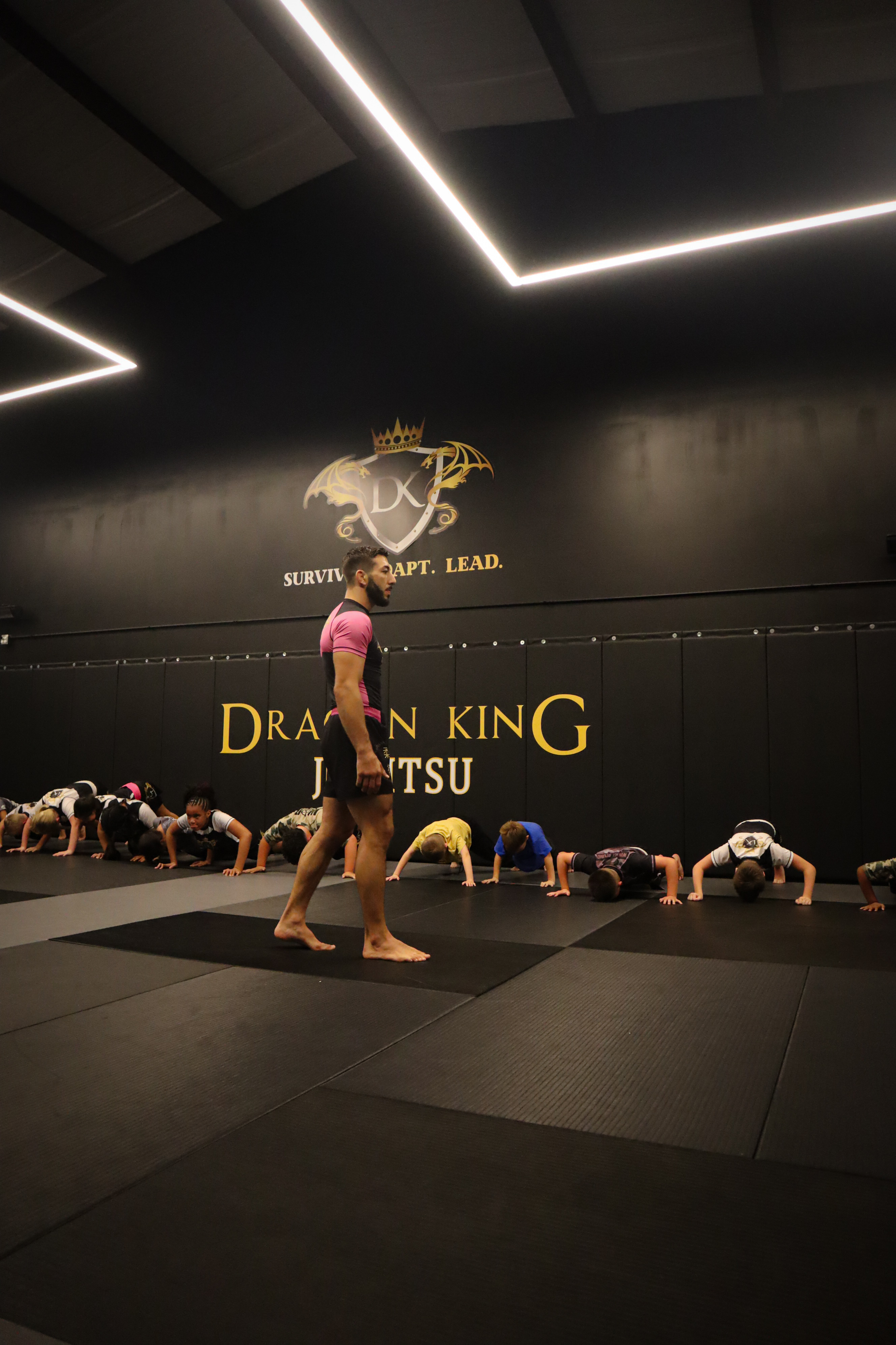 Dragon King instructor with a class of young dragons