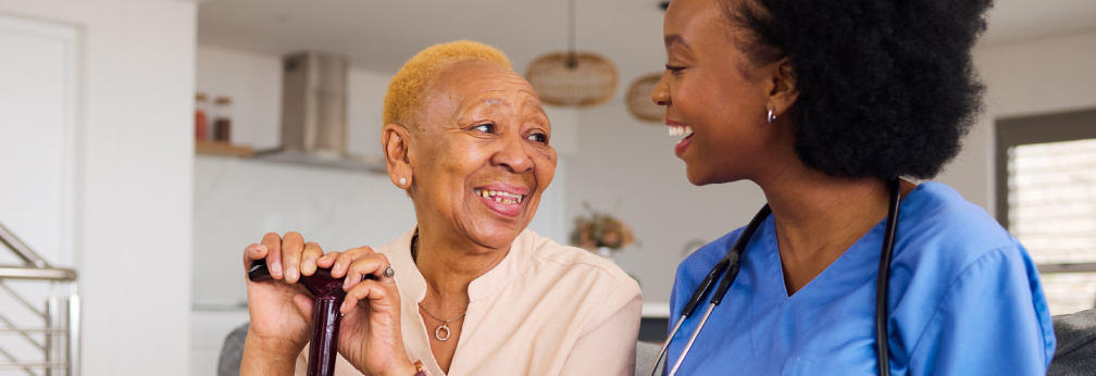 Female nurse smiling with female patient