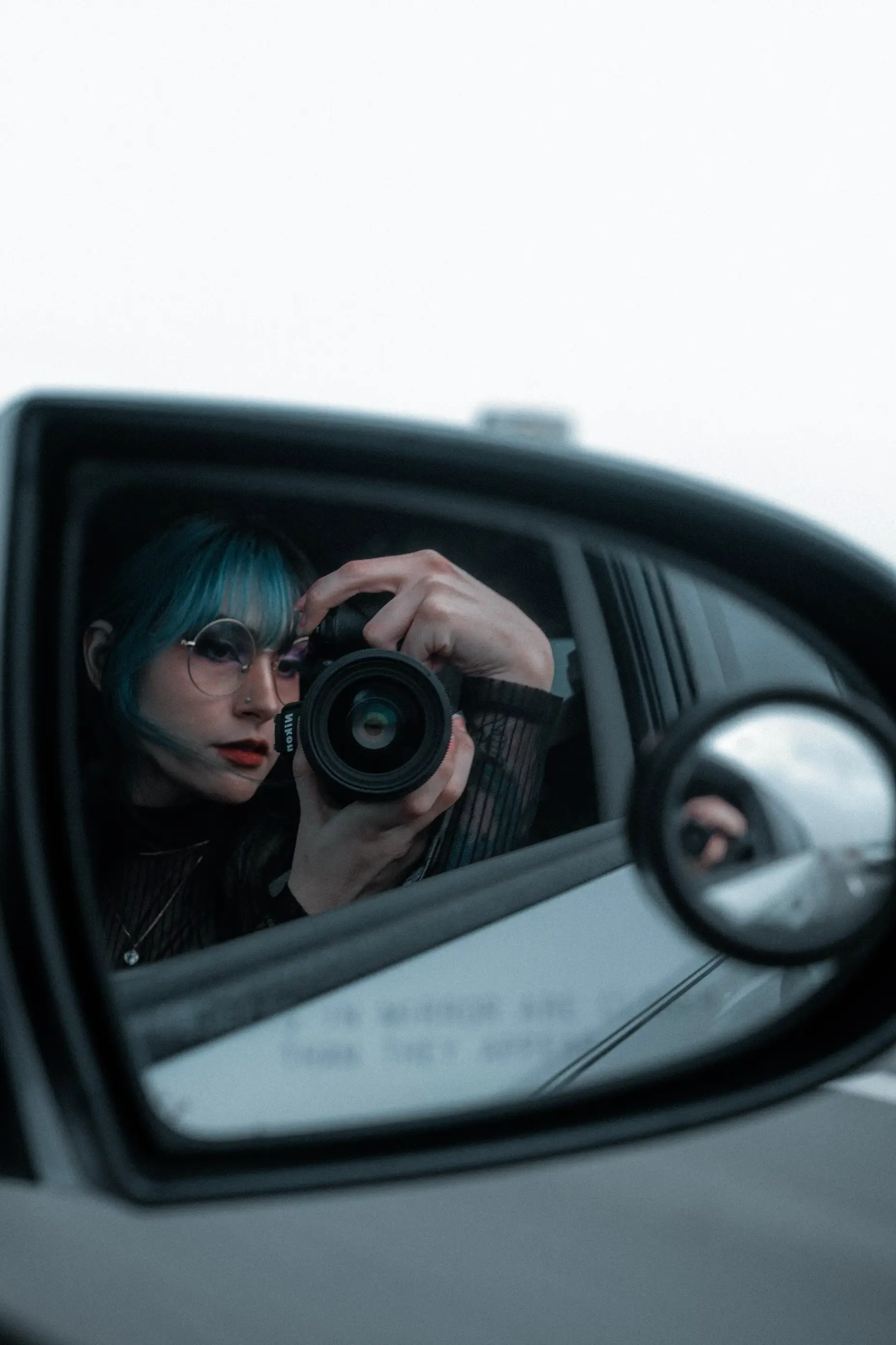 Photograph of dani West taking a photo in the mirror while driving
Dani West Bio | Mobile, AL