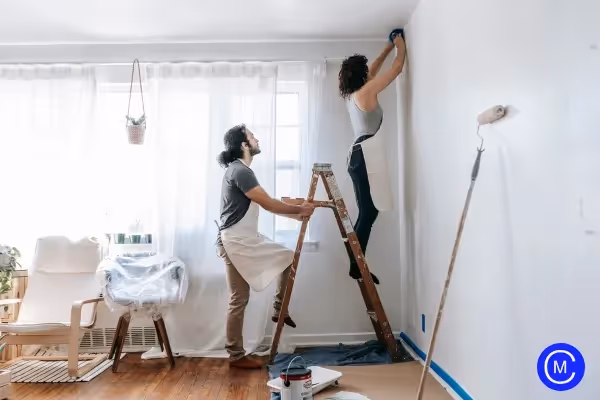 two persons repairing house room