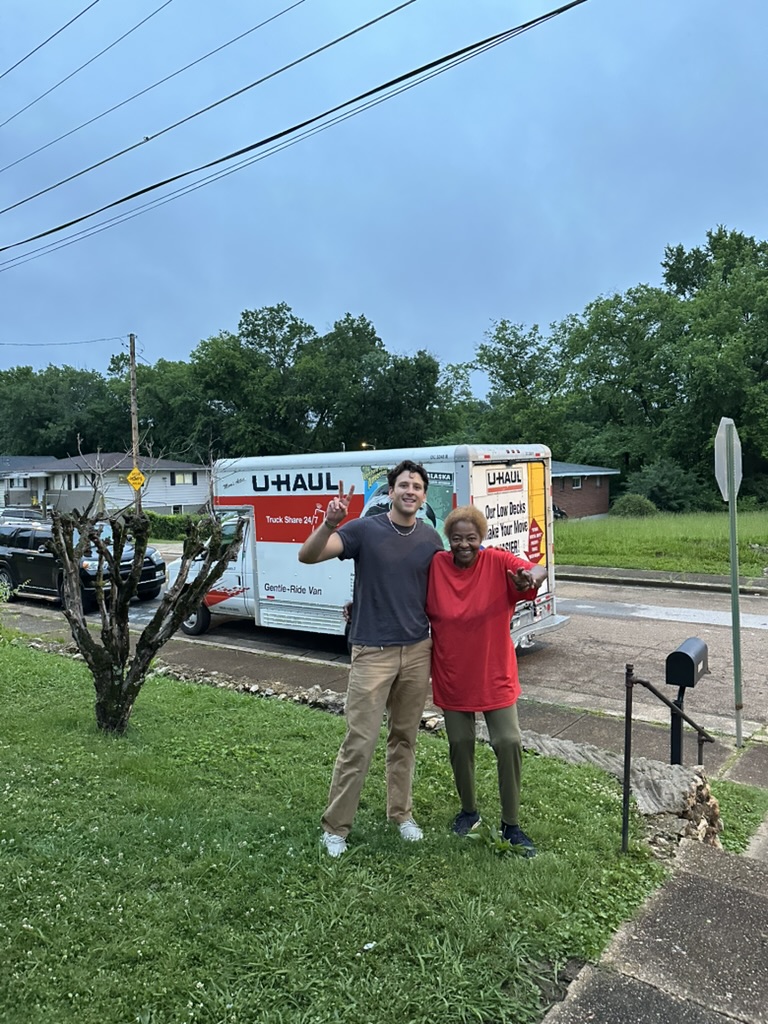 Lucille and Andrew beside the U-Haul on moving day
