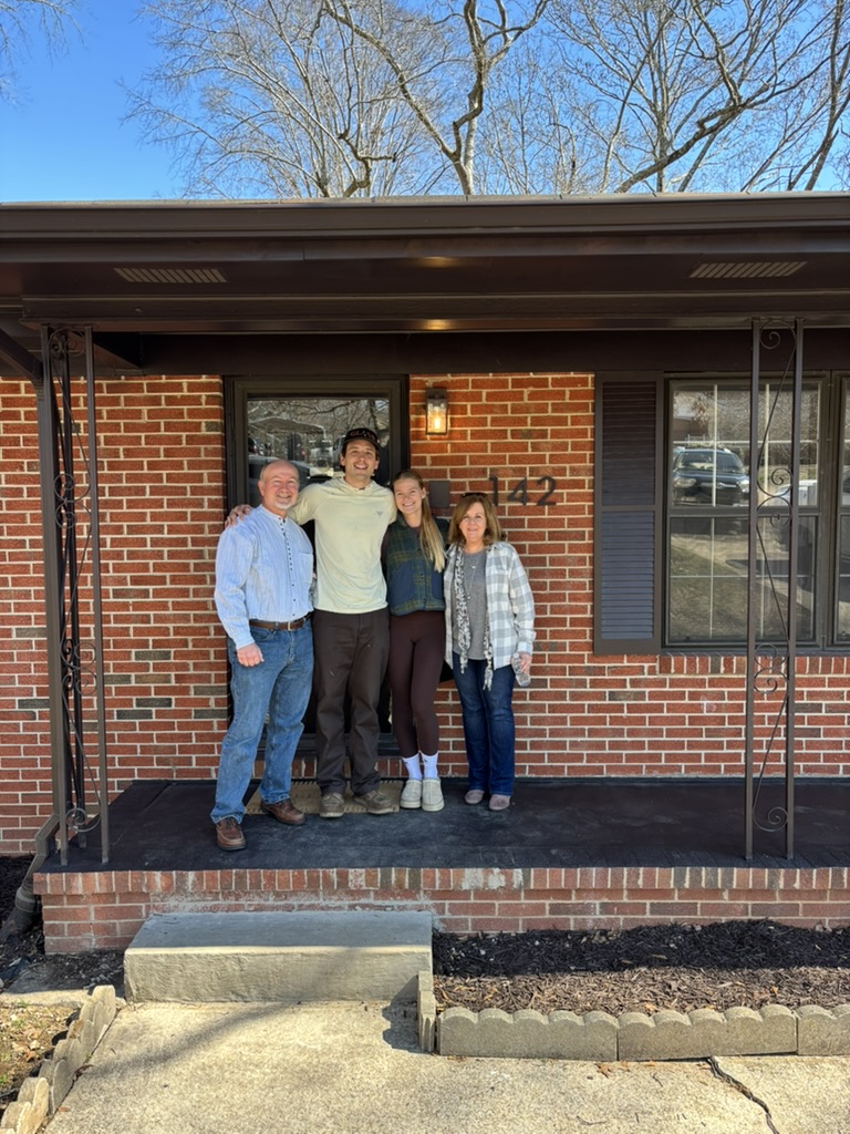 Andrew and Kayla with sellers on the front porch on closing day