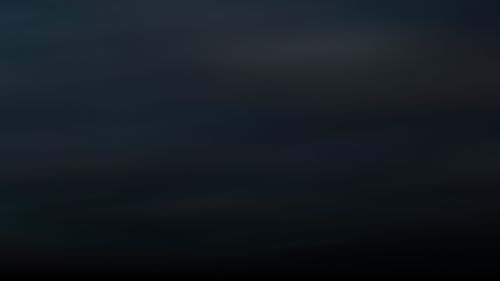 Dark gradient background with subtle shades of black and deep blue.