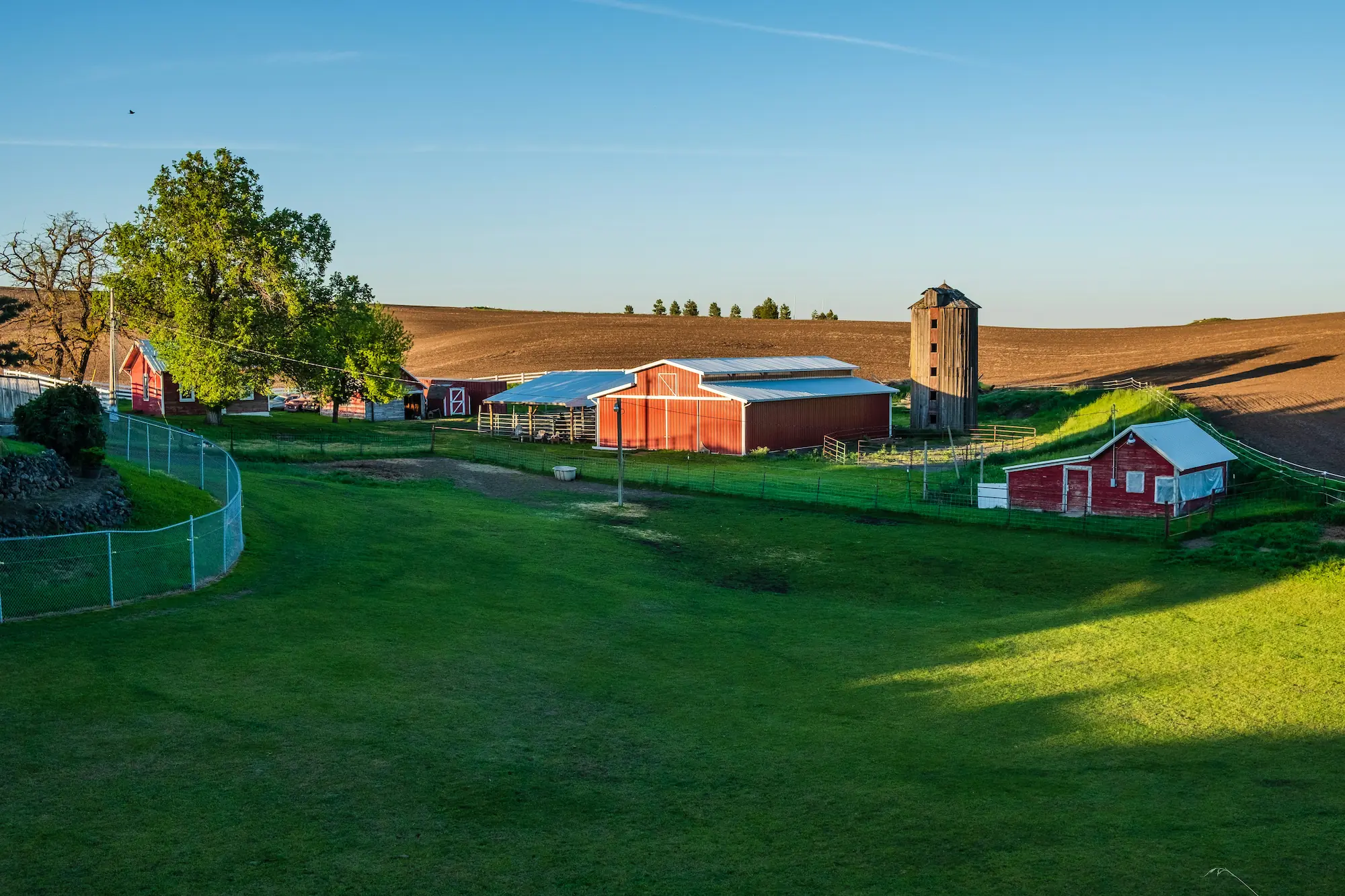 farm with rolling fields and a red barn