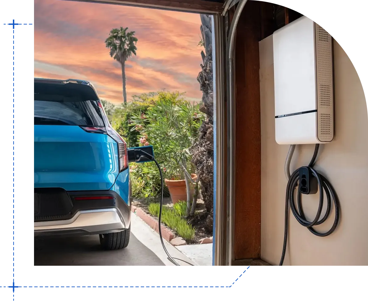 Close-up of an electric car charging with a cable plugged into the port near the rear wheel.