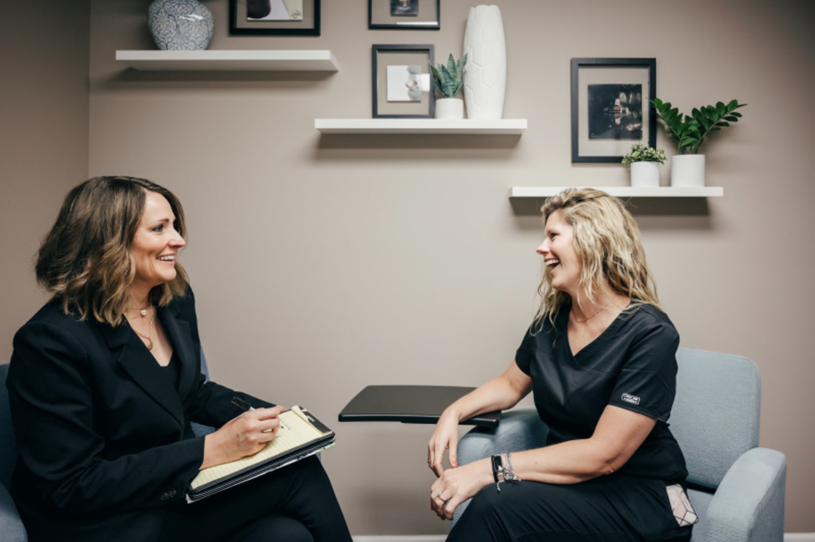 Female dentist having professional conversation with female patient