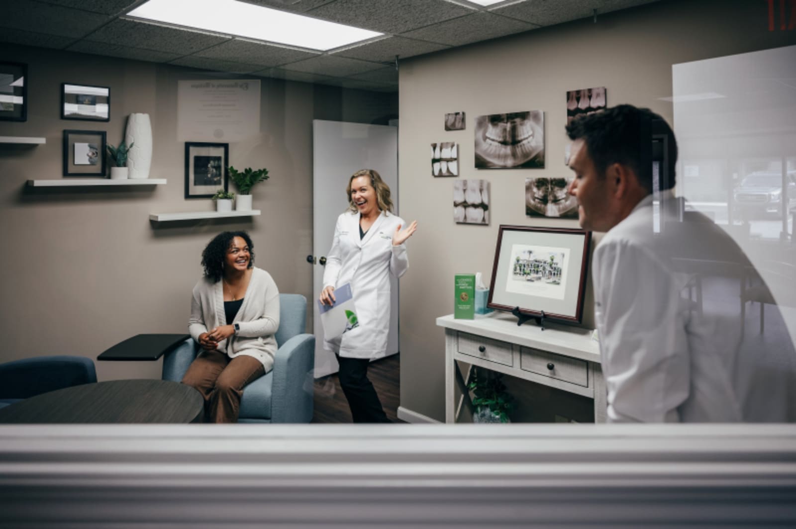 Dentist examining patient at reception desk in clinical setting