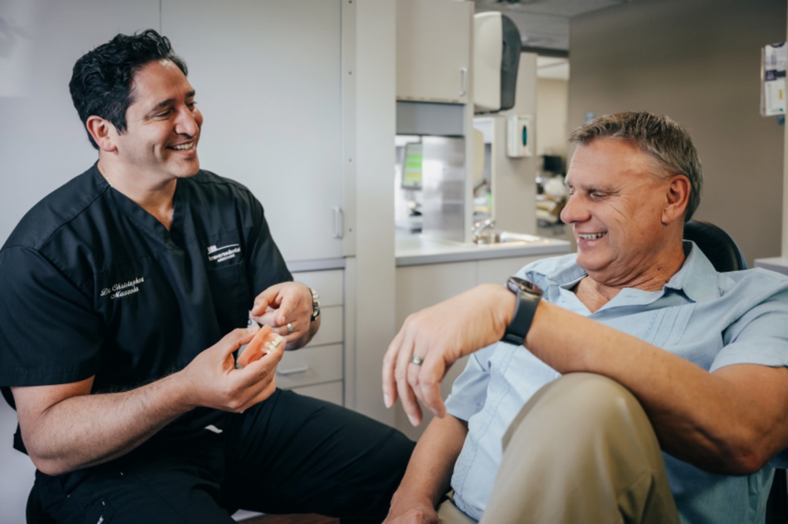 Dentist discussing treatment plan with patient in consultation room