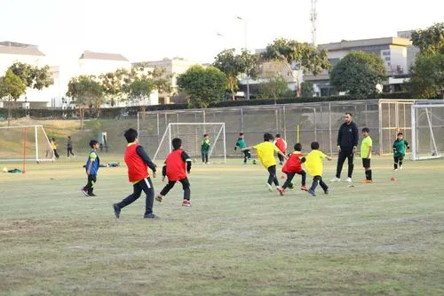 A group of young students running on the pitch