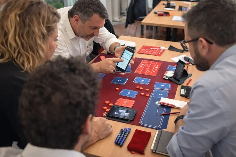 Collaborateurs jouant à un serious game Albus Factory en équipe