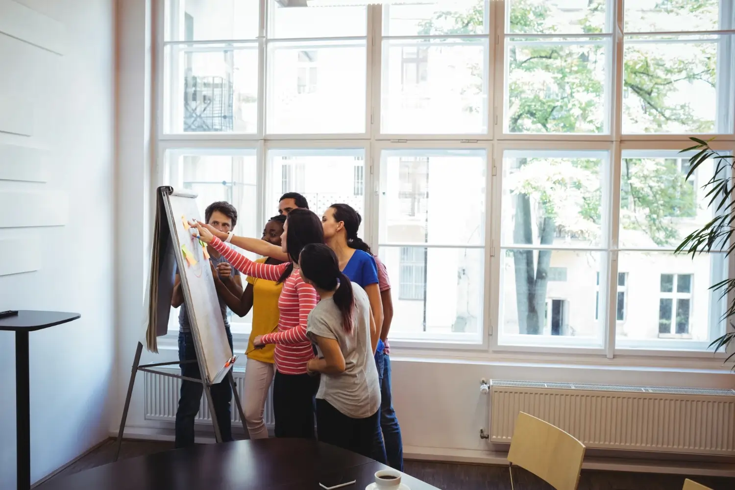 Team discussing in front of whiteboard