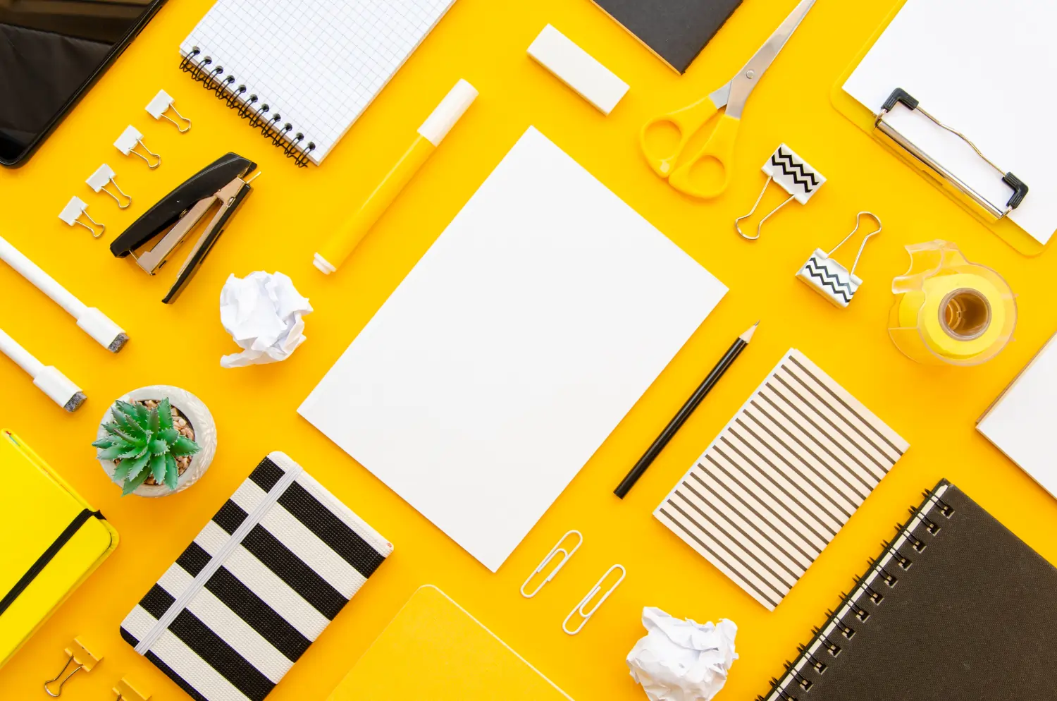 Yellow desk with office stationery