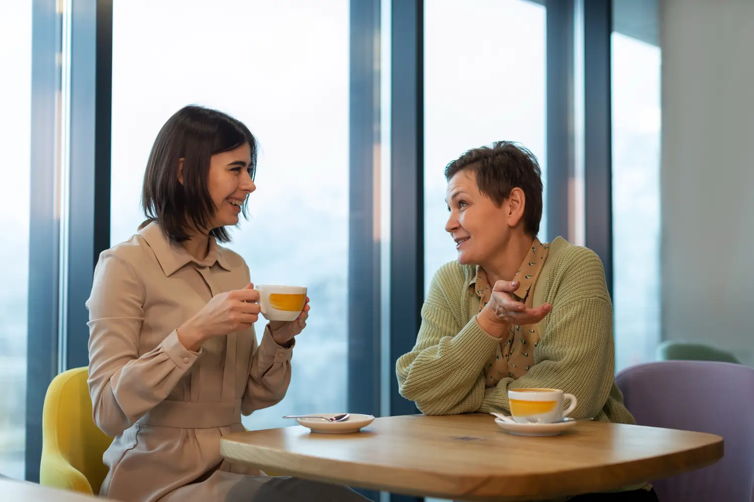 Two colleagues talking over coffee