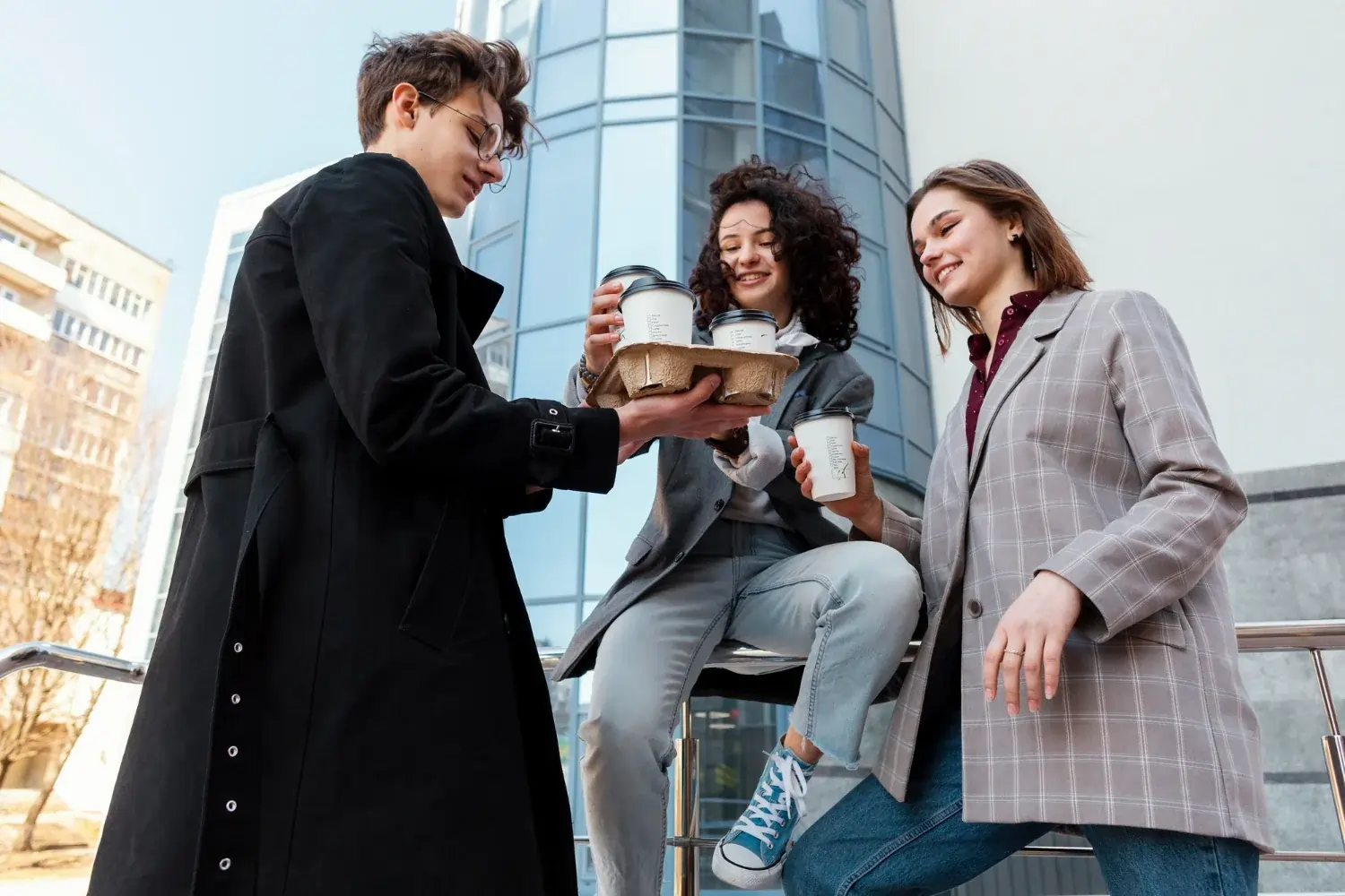 Three people having coffee outdoors