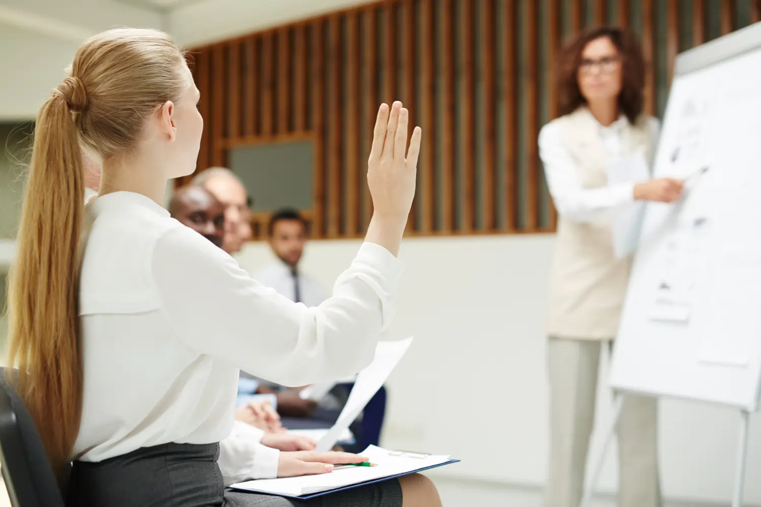 Woman raising hand in workshop