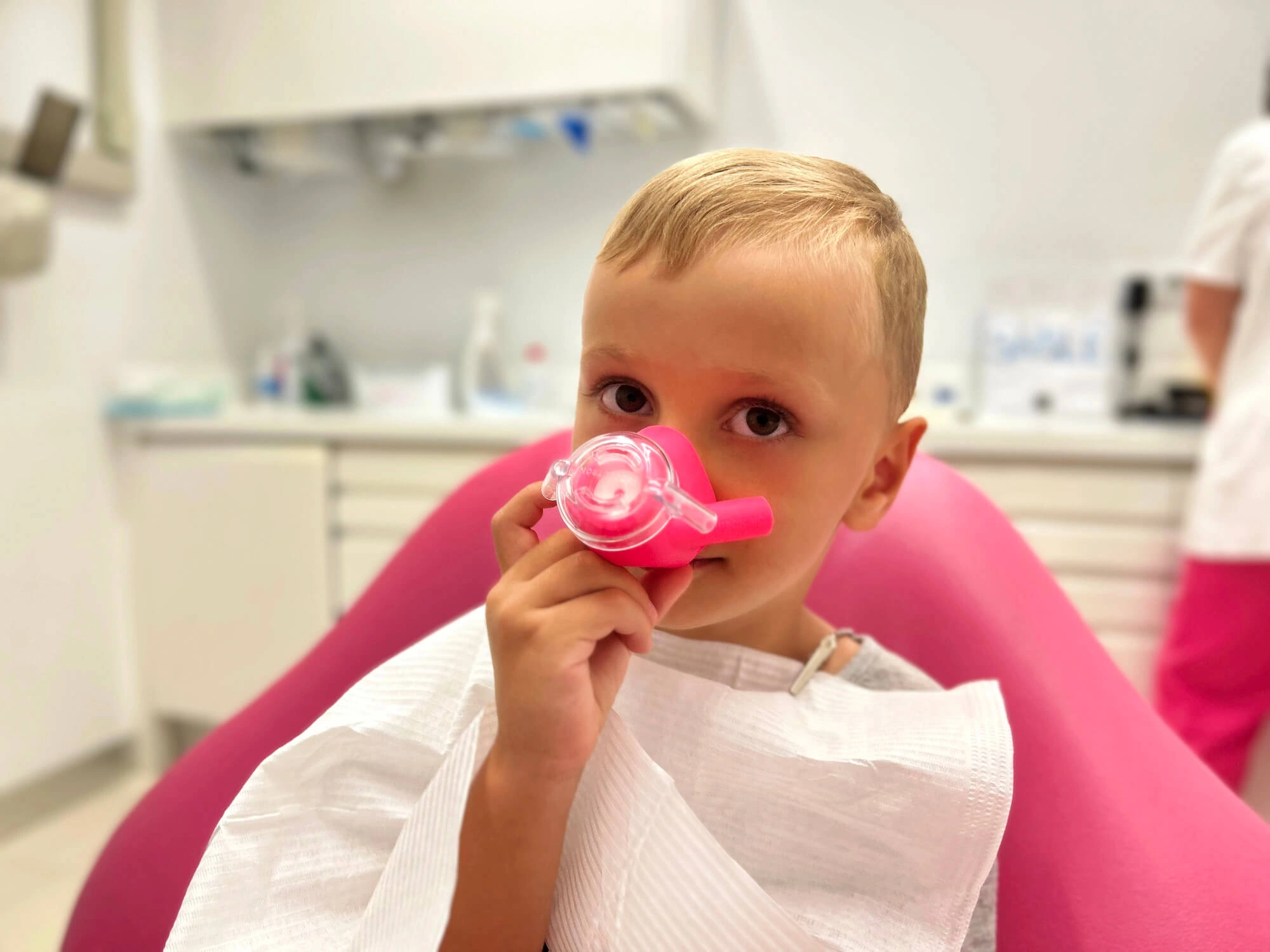 Boy showing the mask to nitrous oxide dentist