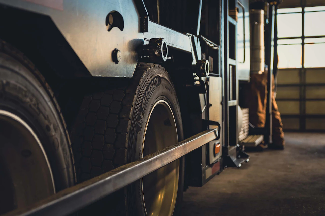 A side view of a truck in a repair bay
