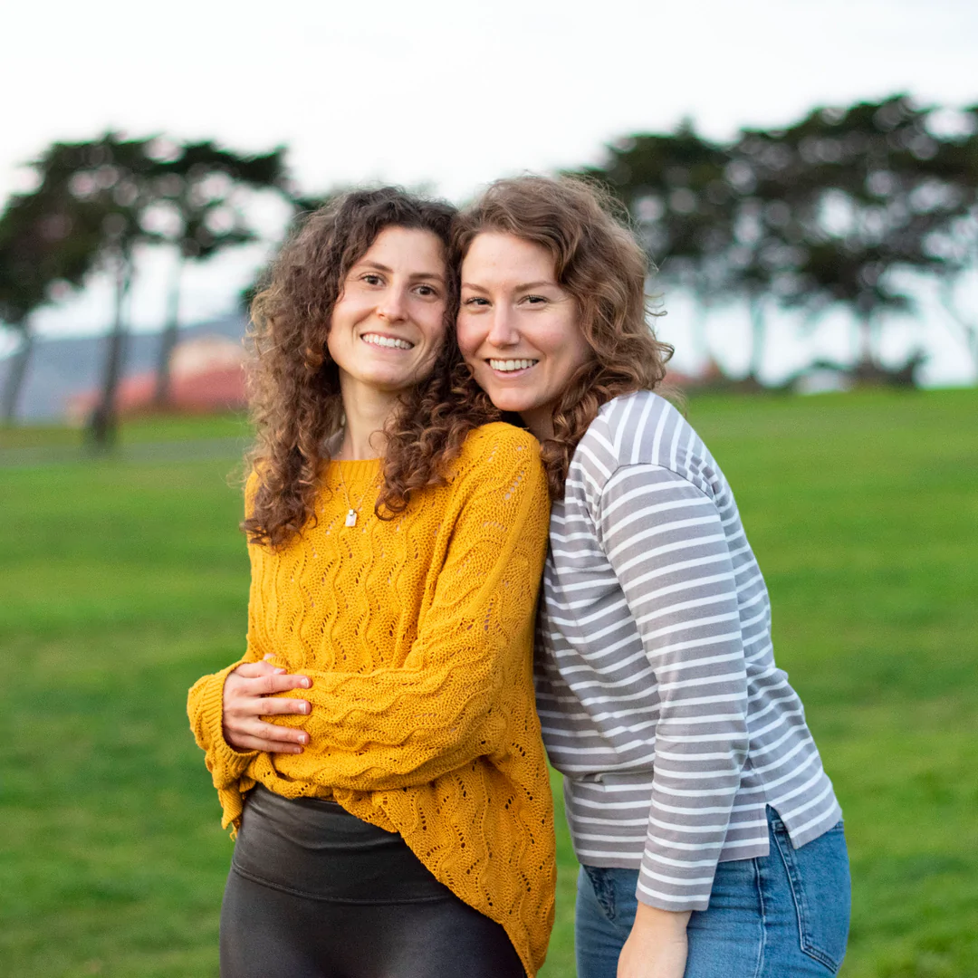 Two sisters smiling together outdoors, representing Lianna Soap's connection to home, love, and the planet.