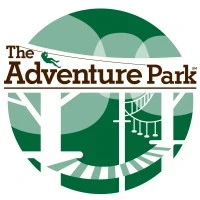 Logo of The Adventure Park, featuring trees and zipline elements, promoting climbing and zipline adventures.