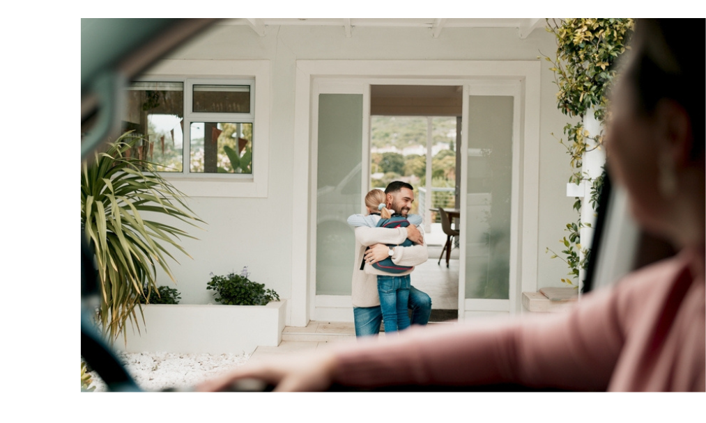 Father and daughter hug in front of their family home, after a family member has dies without a will.