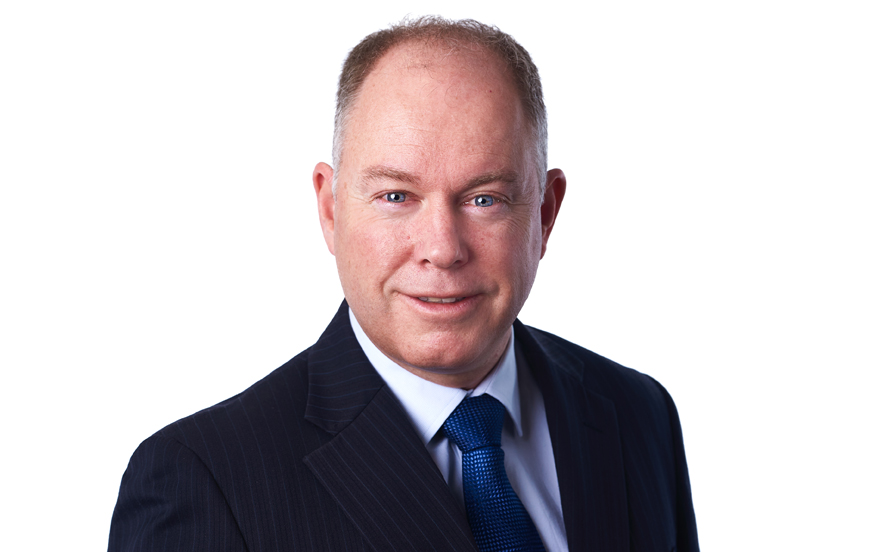 Headshot of James Turner, Partner at McVeagh Fleming, professional style photo against light background.