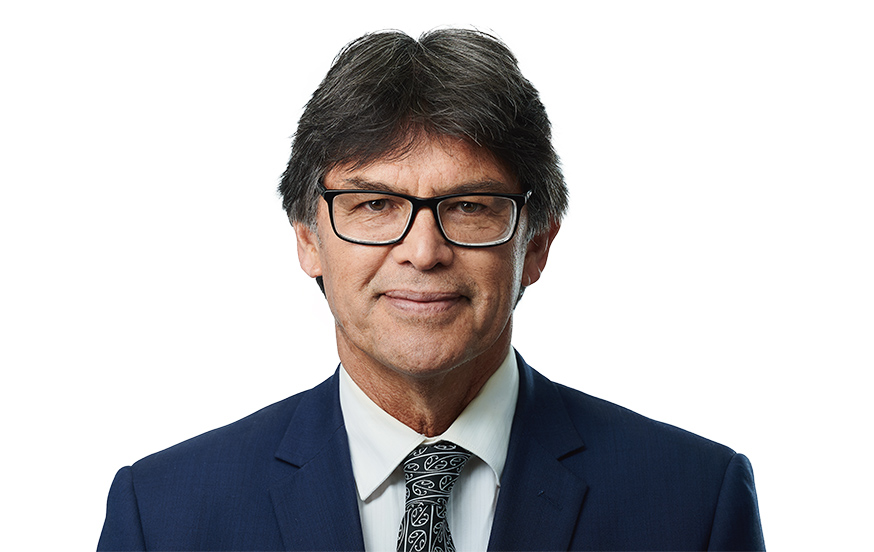 Headshot of John Burley, Partner at McVeagh Fleming, professional style photo against a neutral background.