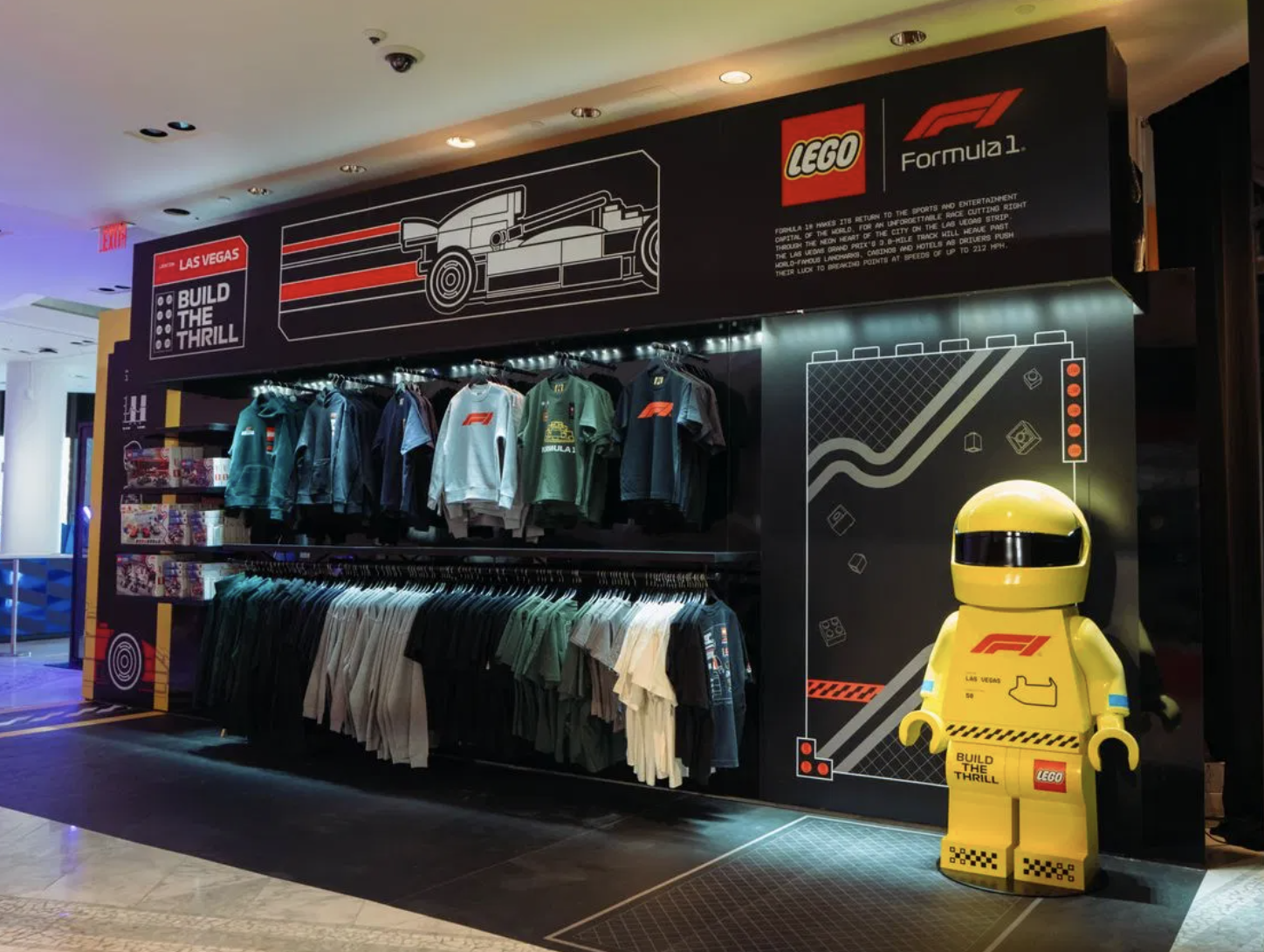 Five-foot tall custom fabricated giant LEGO minifigure outdoors at the F1 Las Vegas GP installation — high-fidelity replica painted in classic LEGO colors.