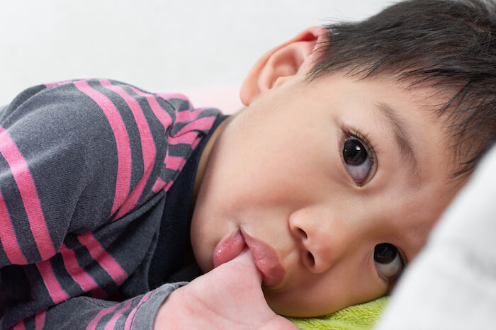child sucking his thumb