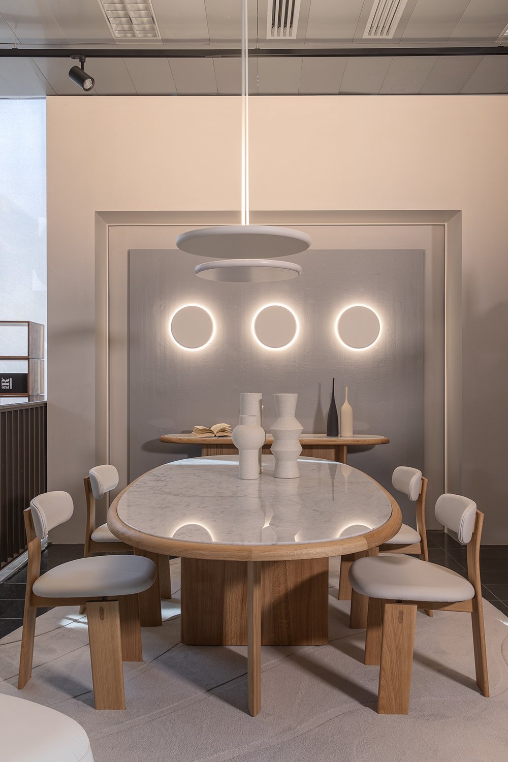Heiko dining chairs by Tollgard & Castellani for Riva 1920 in solid oak around an oval marble-topped table