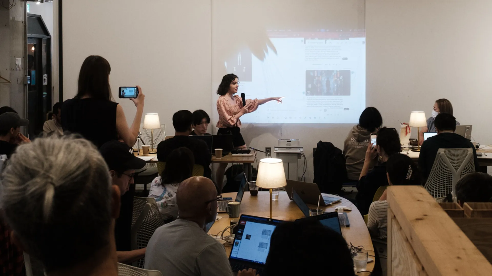 A speaker presenting to attendees at an AIMovieStudio workshop