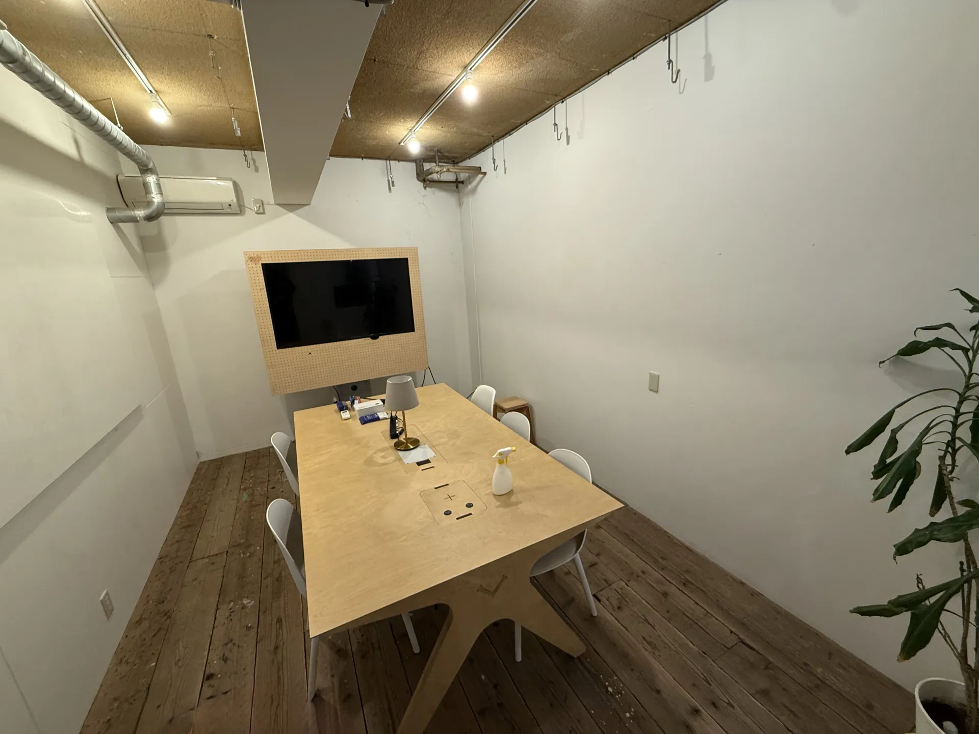 A small meeting room with one shared table, set up for a small-group class