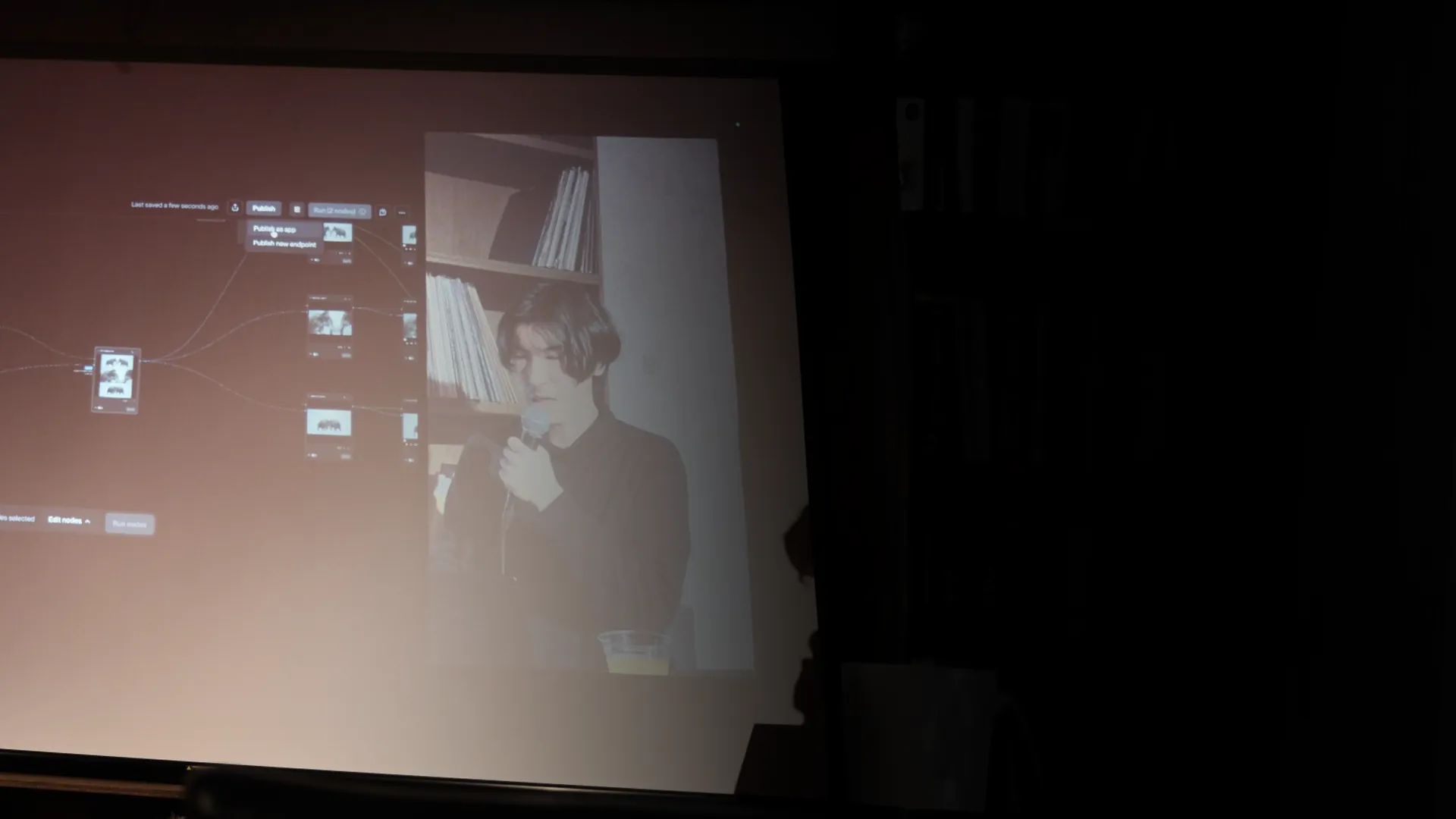Hero Kominato on screen, presenting a node-based AI workflow at a meetup