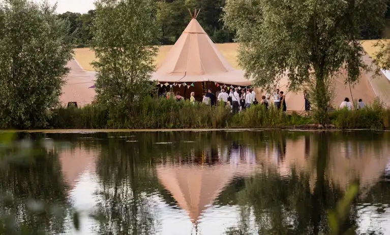 giant tipis over a lake venue