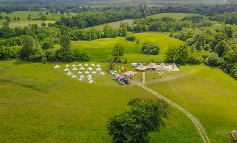 3 Giant Hats looking over a lake