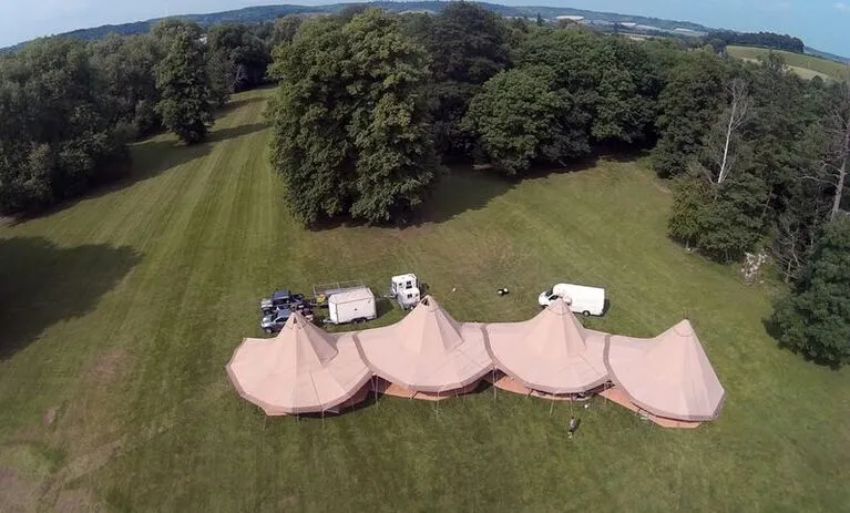 giant tipis over a lake venue