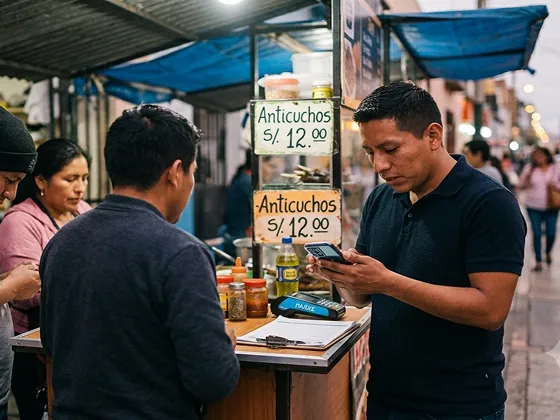 Man paying at street food stand selling anticuchos for 12 soles in a busy outdoor market.