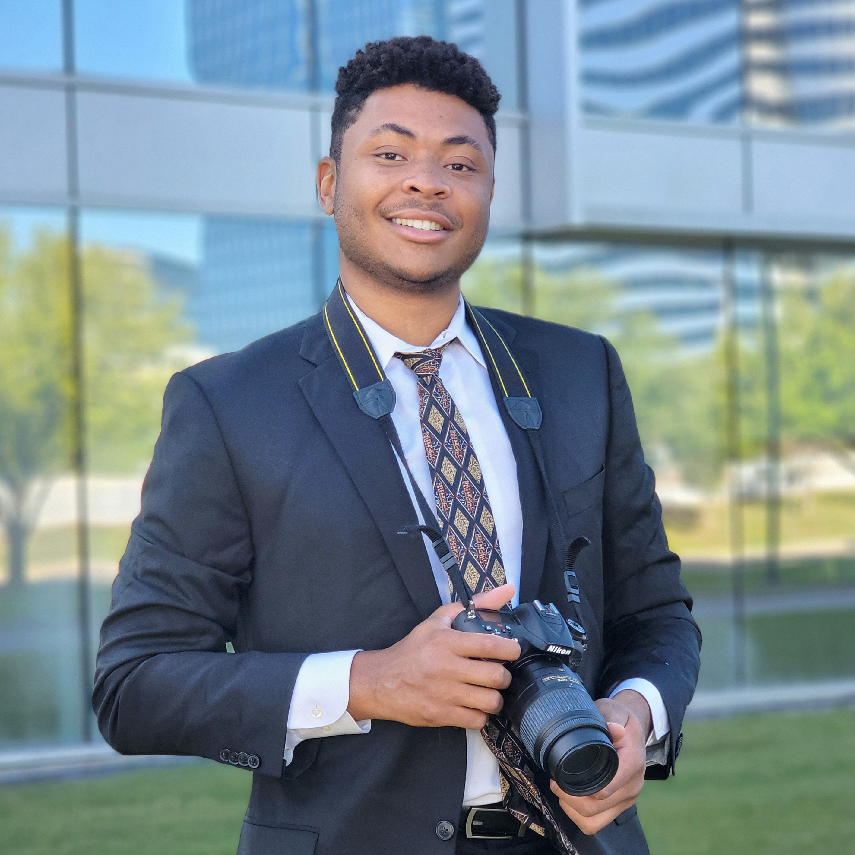 A headshot of Cyrus Codner in a suit