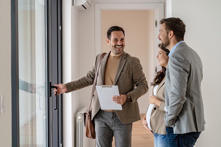real estate agent showing clients around house