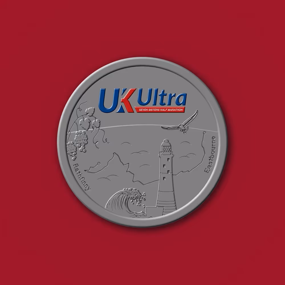 Silver medal with "UK Ultra" logo and lighthouse design on a red background.