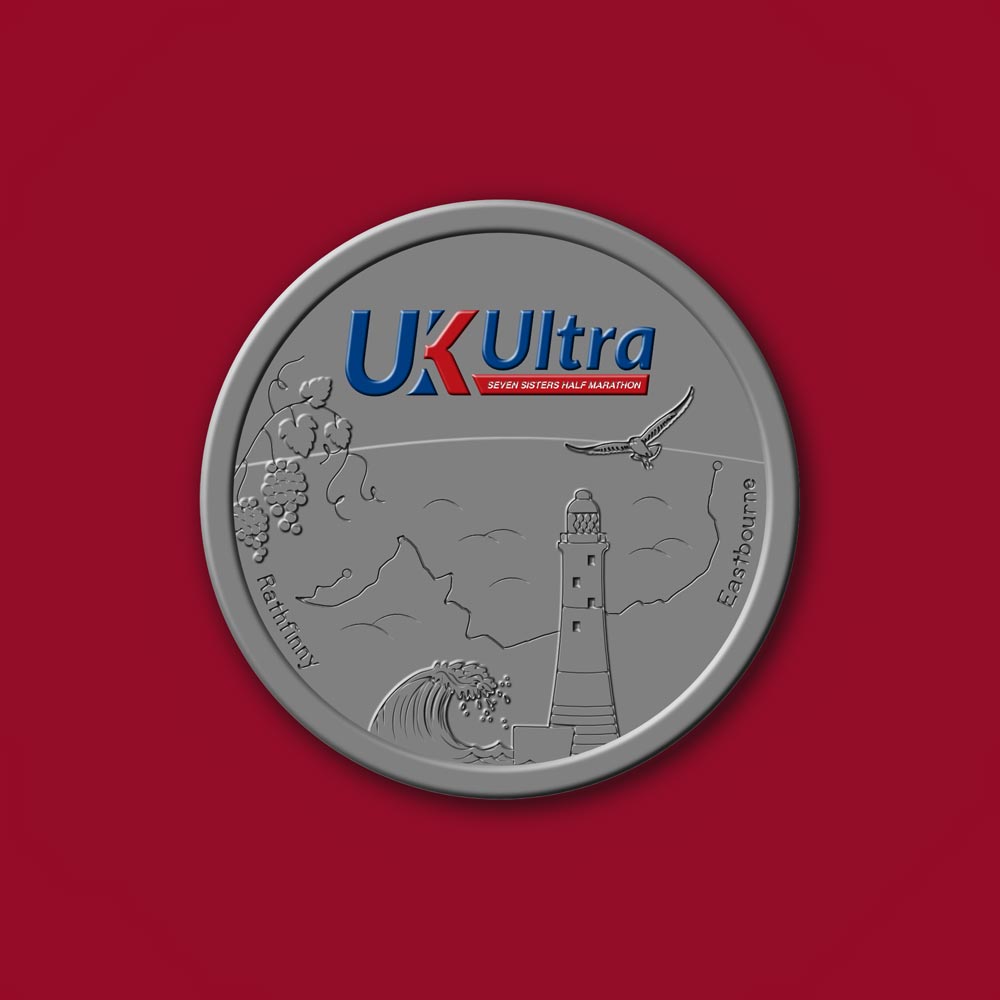 Silver medal with "UK Ultra" logo and lighthouse design on a red background.