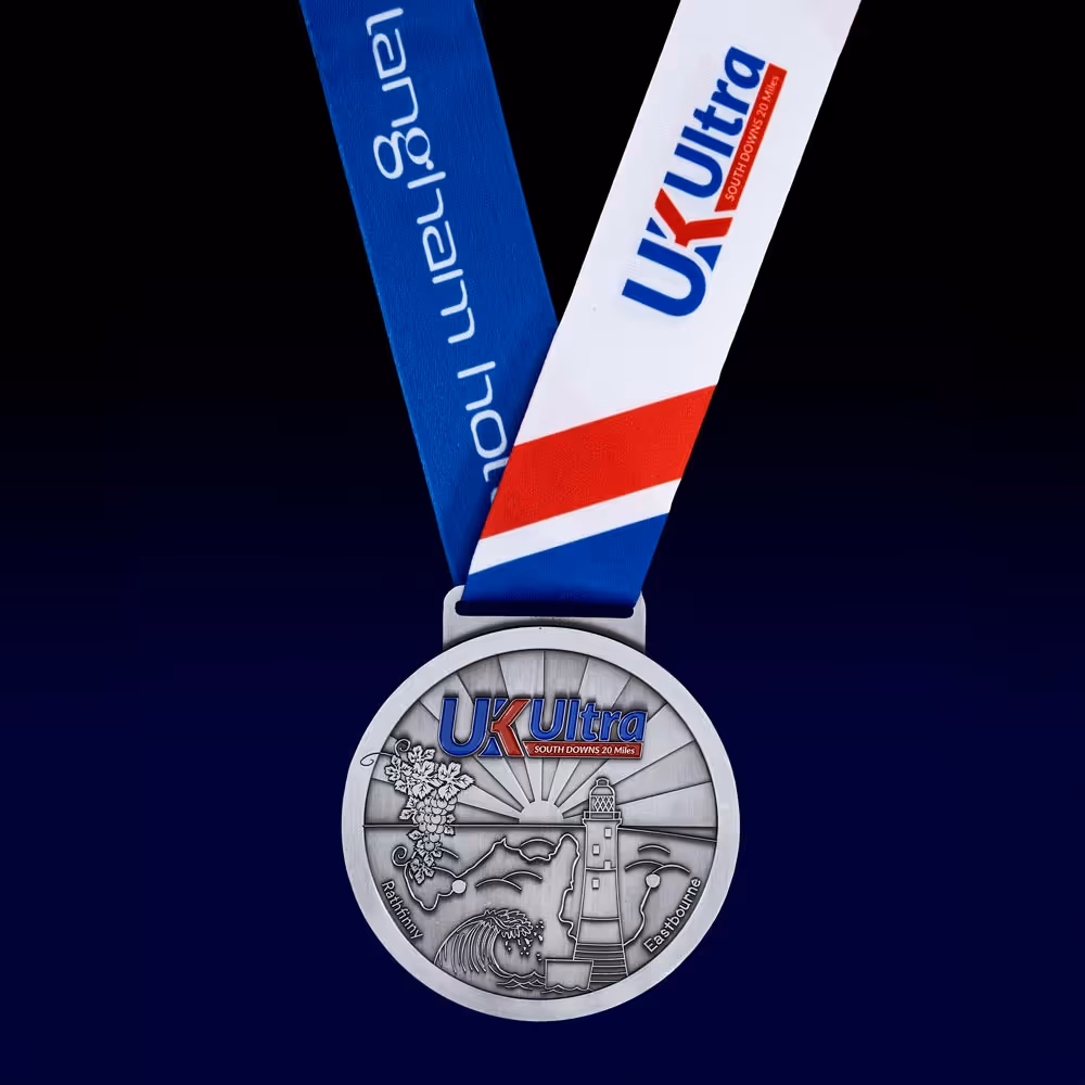 A silver medal with "UK Ultra" logo and a blue and red ribbon attached.