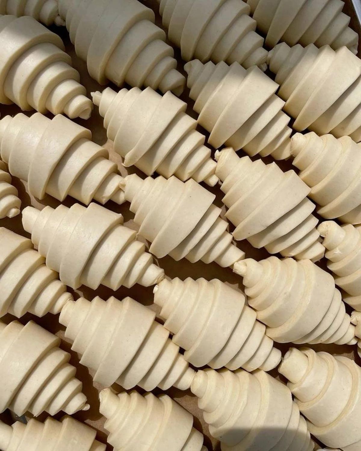 a table full of unbaked Croissants