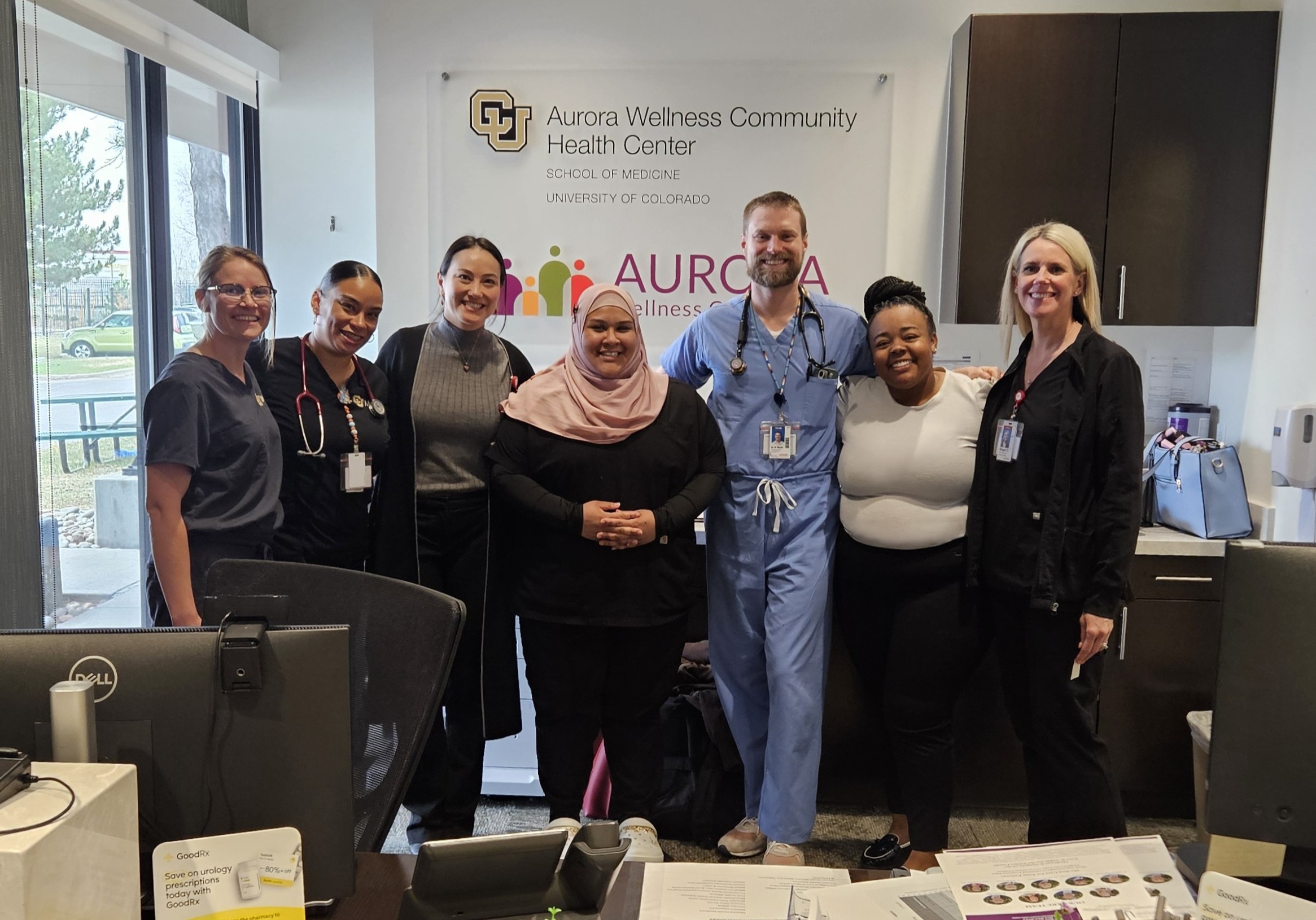 AECHC staff posing together in front of clinic sign.