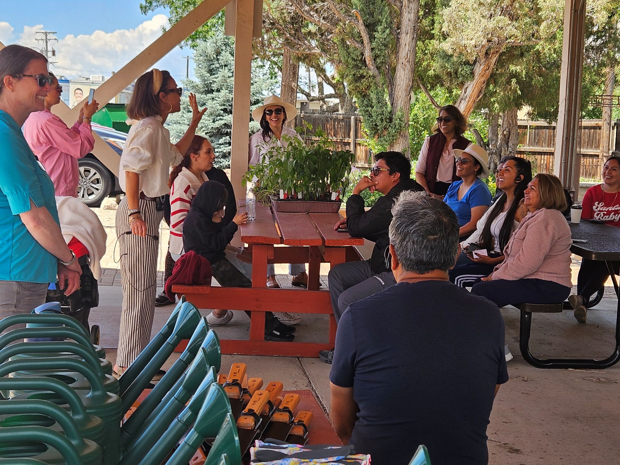 A group of people at the August Community Breakfast clap for the presenter.