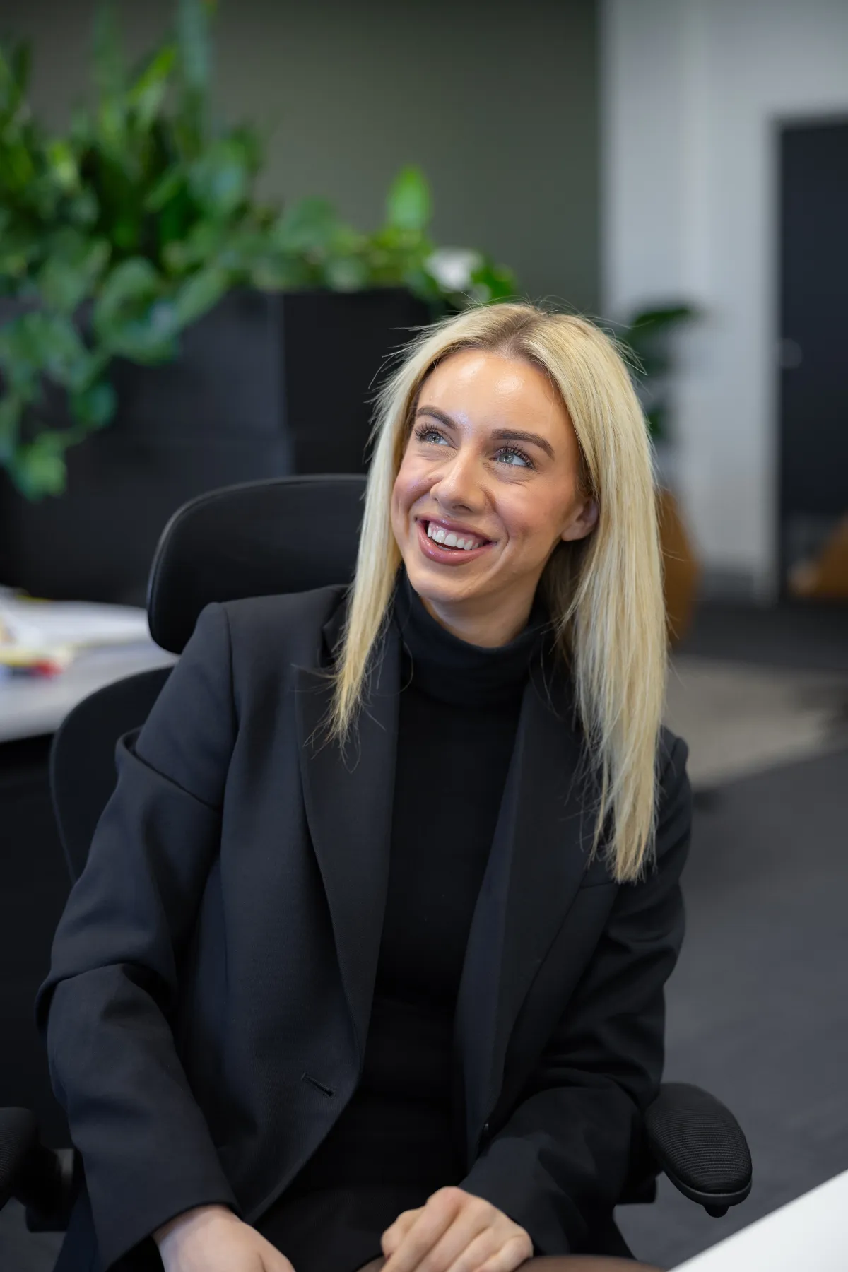 Tayla McPhee, solicitor at VRT Lawyers, speaking with a colleague at her desk
