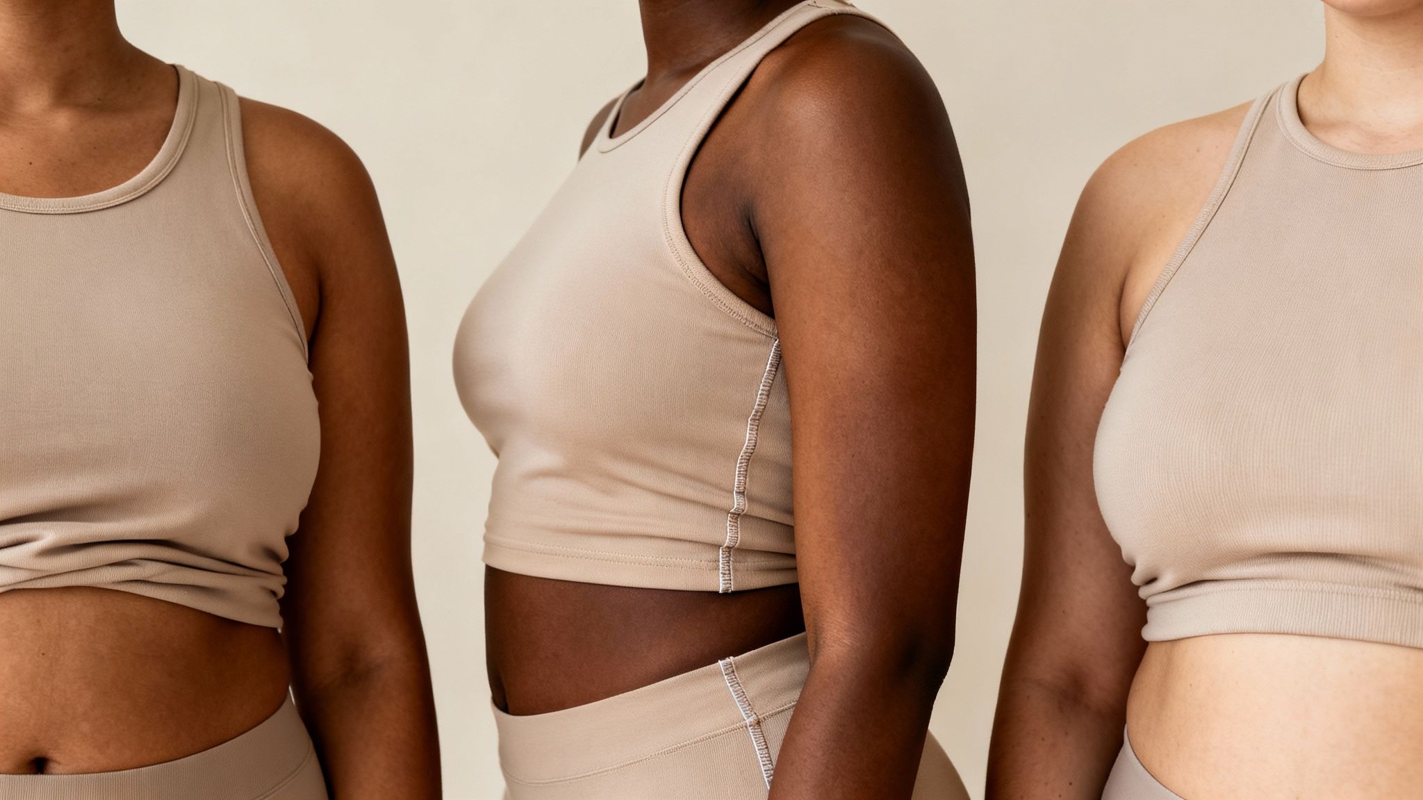 Close-up of three women with diverse body types wearing beige athletic tops, showcasing natural bodies.