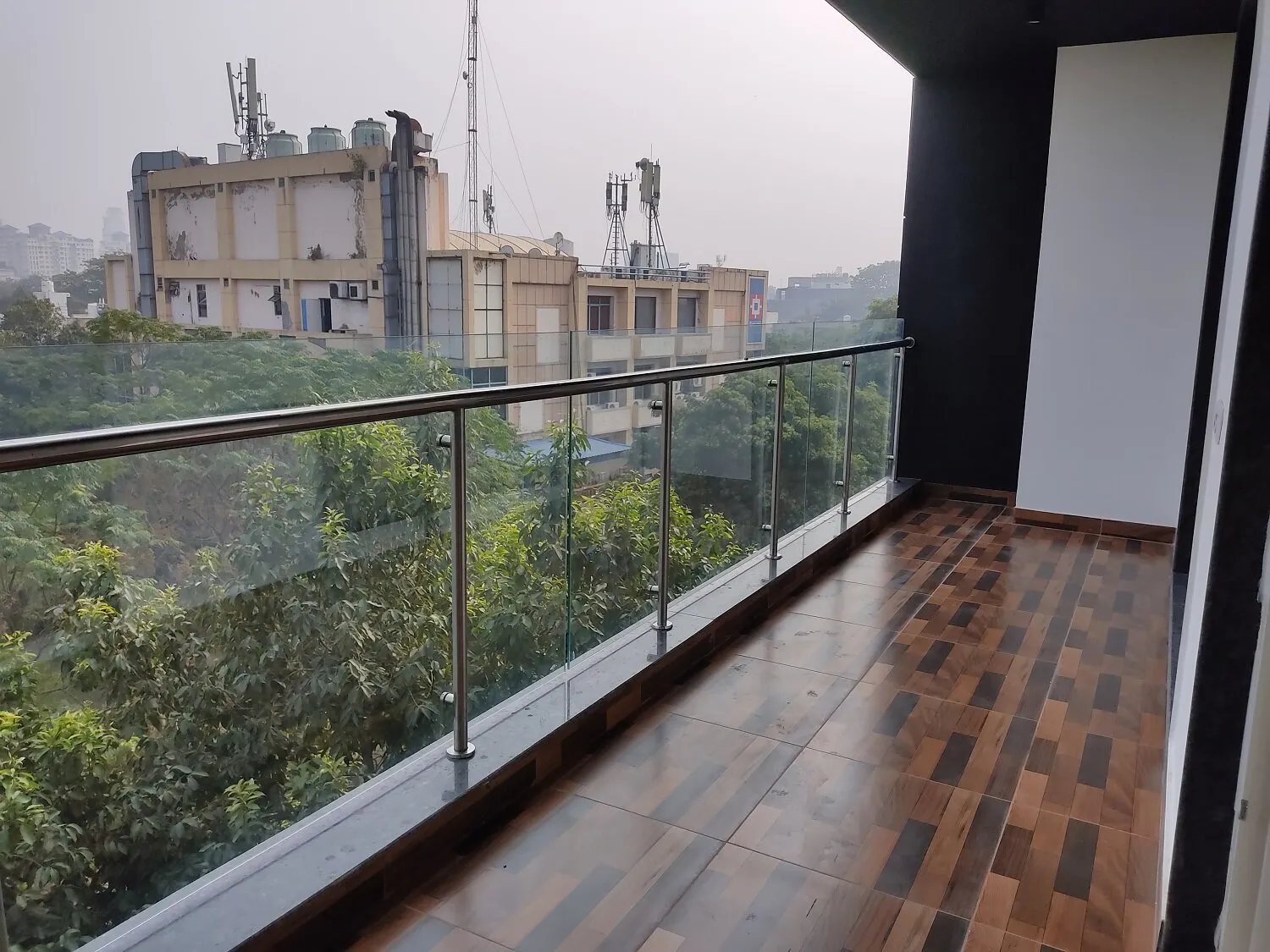 View of the balcony at the front of the building with view of the gardens in front if the building